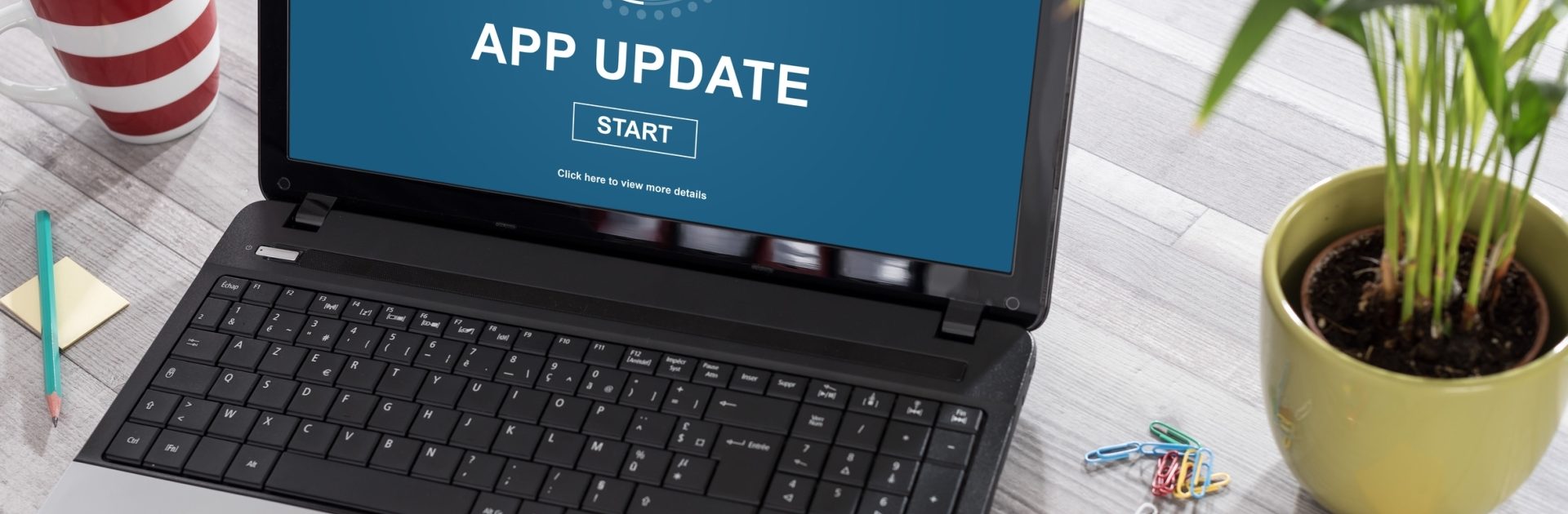 Laptop on a desk with application update concept on the screen